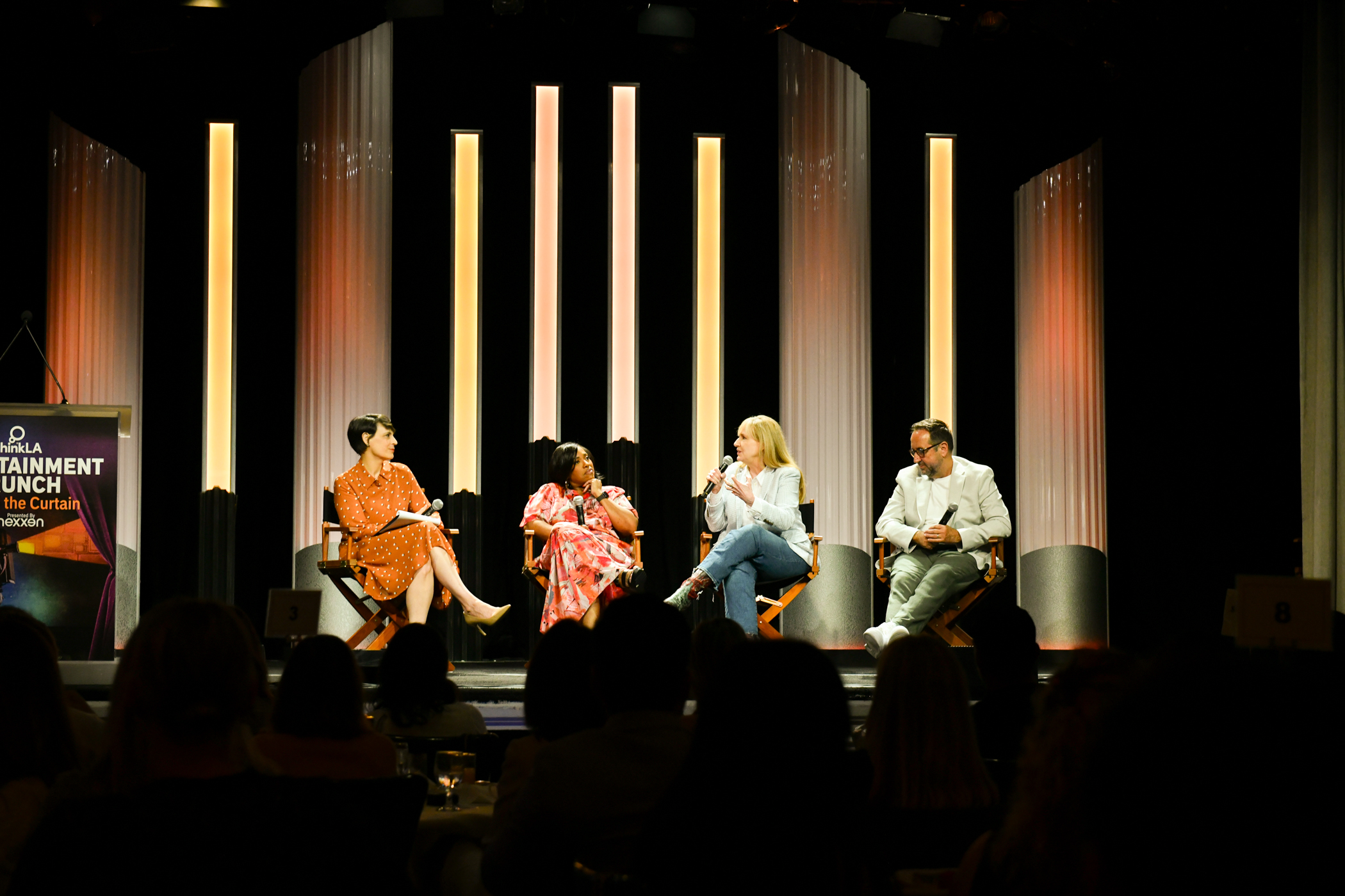 Four panelists sit on a stage during a discussion at the Beverly Hilton hotel