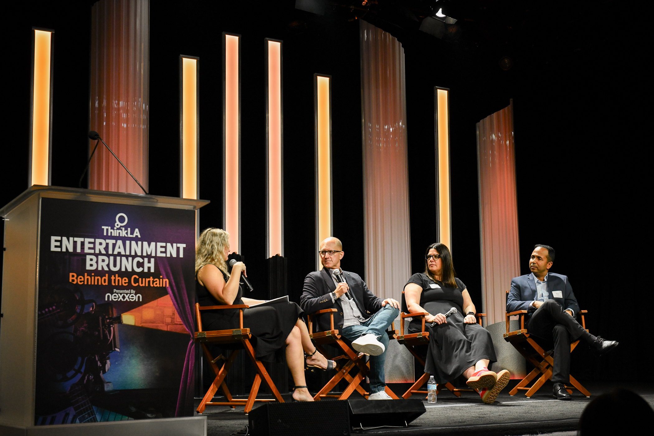 Four panelists sit on a stage at the Beverly Hilton during an entertainment brunch