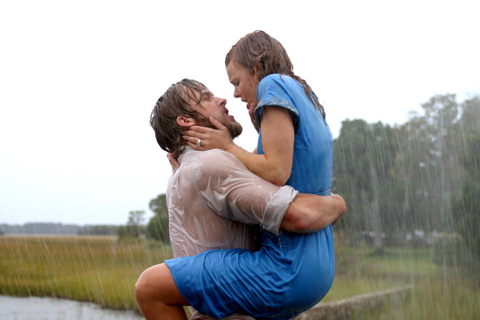 Ryan Gosling holds Rachel McAdams in a passionate embrace in the rain, both soaked, from a famous scene in "The Notebook."