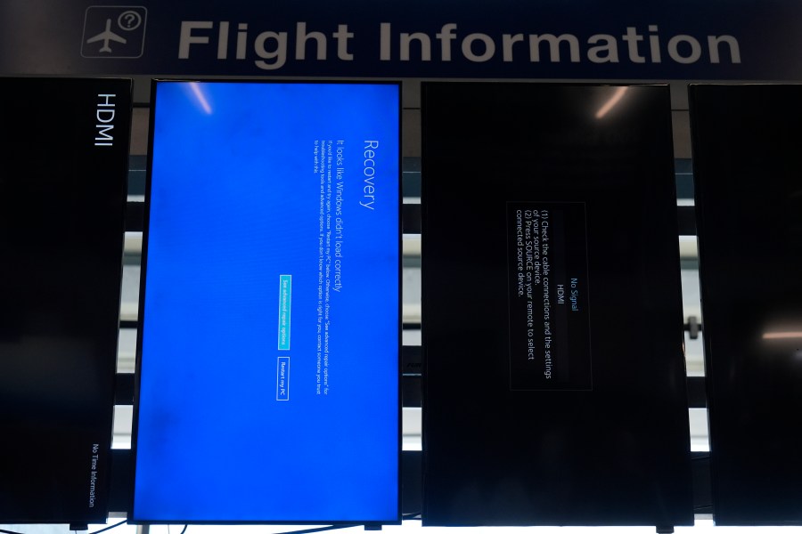 A "blue screen of death" is displayed instead of flight information at Chicago O'Hare International Airport after a software glitch caused widespread outages as reported by airlines around the world, Friday, July 19, 2024, in Chicago. (AP Photo/Erin Hooley)