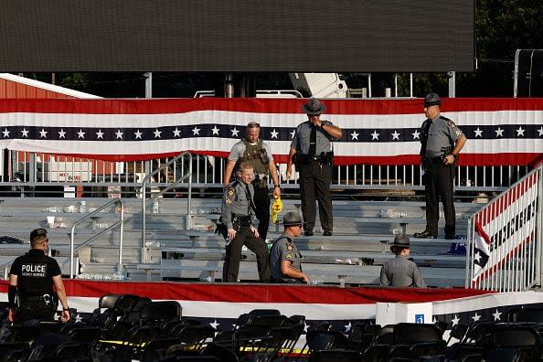 BUTLER, PENNSYLVANIA - JULY 13: Law enforcement agents stand near the stage of a campaign rally for Republican presidential candidate former President Donald Trump on July 13, 2024 in Butler, Pennsylvania. According to Butler County District Attorney Richard Goldinger, the suspected gunman is dead after injuring former President Trump, killing one audience member and injuring at least one other. (Photo by Anna Moneymaker/Getty Images)