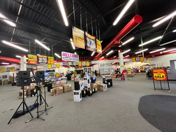 Signs listing the final sale prices for musical equipment is shown inside Sam Ash. (Frank Mecham- The News-Herald.)